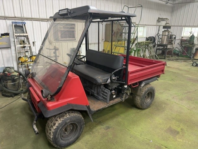 Red semi truck with aluminum grain trailer
